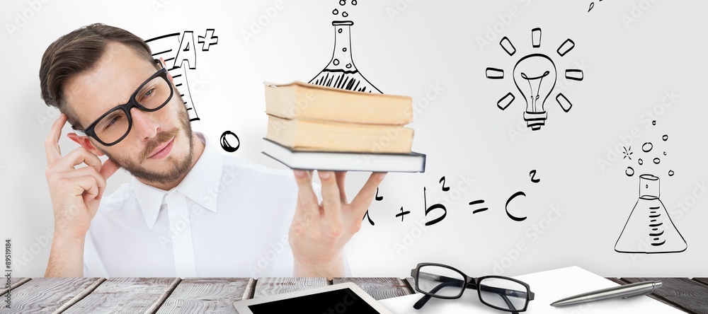 Composite image of geeky young man looking at pile of books