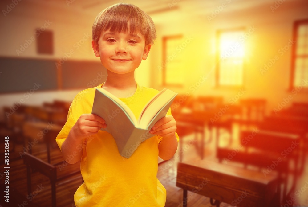 Composite image of happy pupil with book