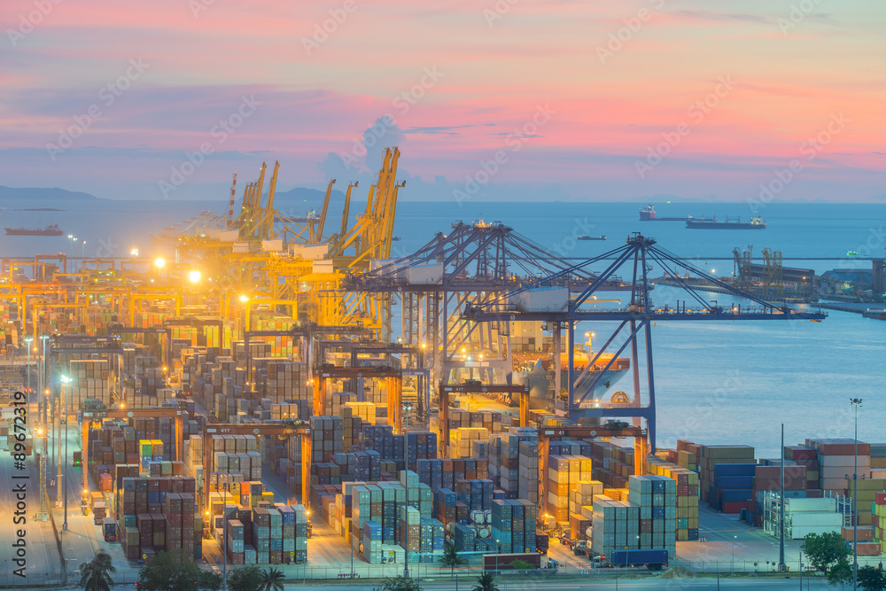 Container Cargo freight ship with working crane bridge in shipyard at dusk for Logistic Import Expor