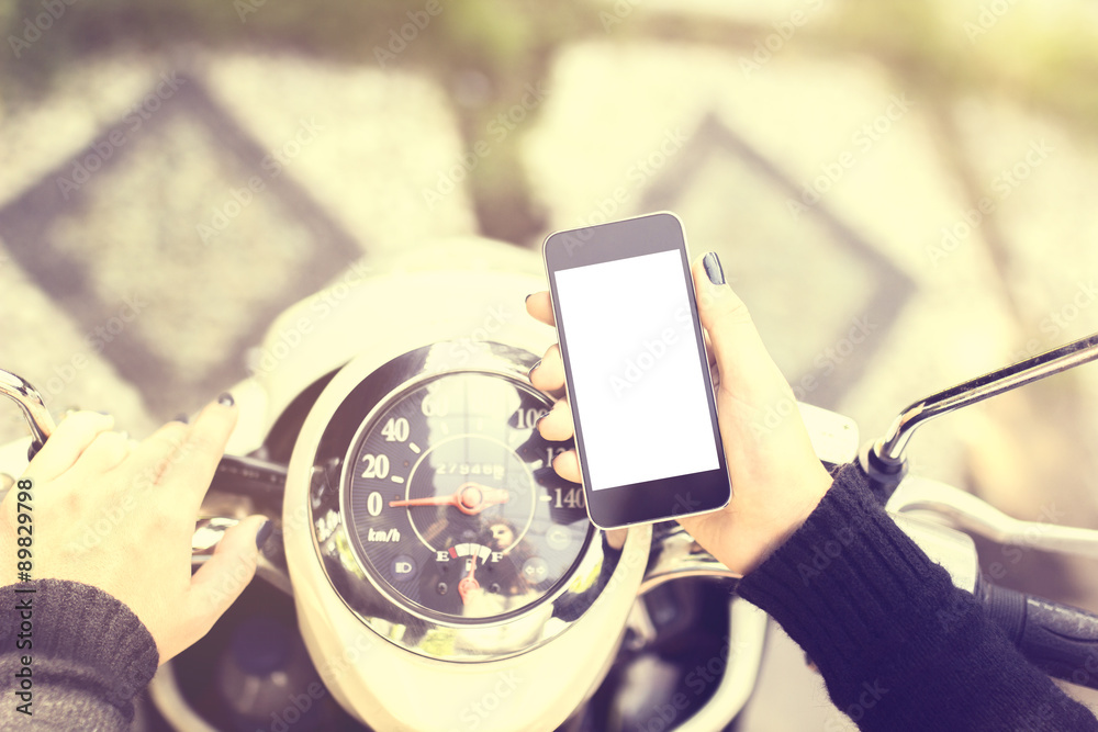 girl on a motorbike with a blank cell phone