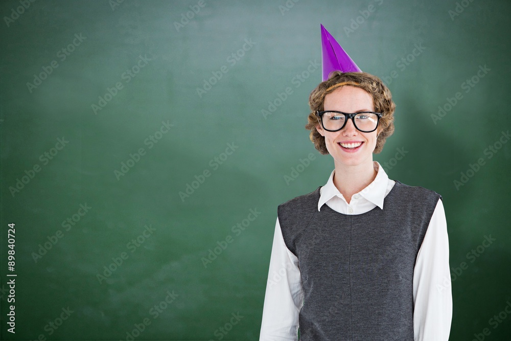 Composite image of geeky hipster wearing a party hat