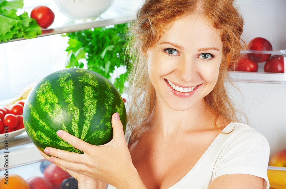 Happy woman and open refrigerator with fruits, vegetables and he