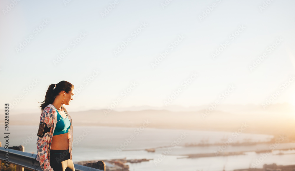 Fit young woman runner standing outdoors