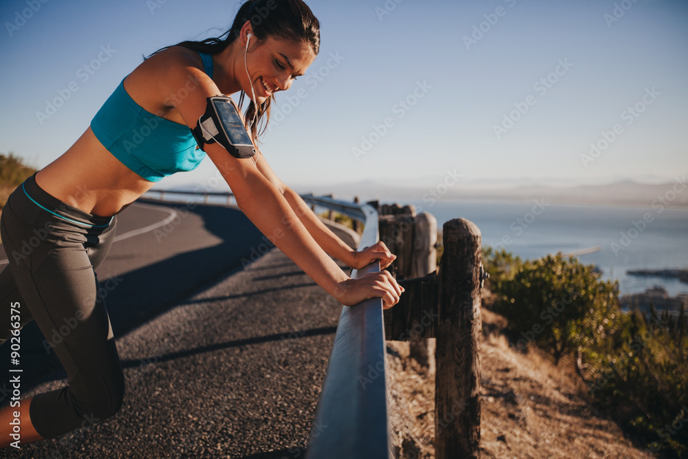 Runner leaning on road rail taking a break