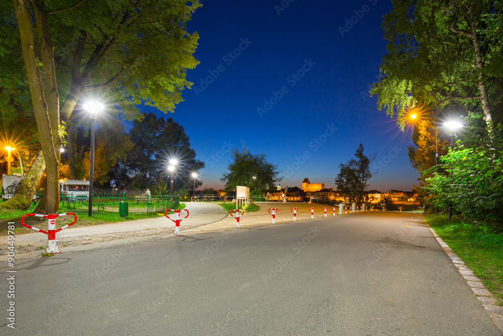 Parking at the Vistula river with night view for old town of Torun, Poland