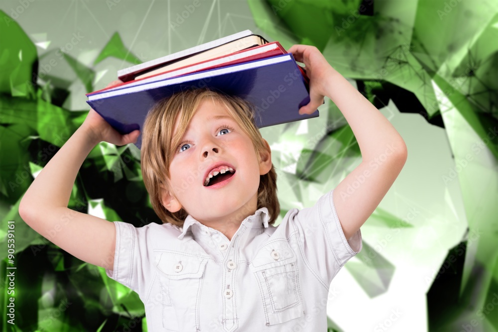 Composite image of cute pupil holding books