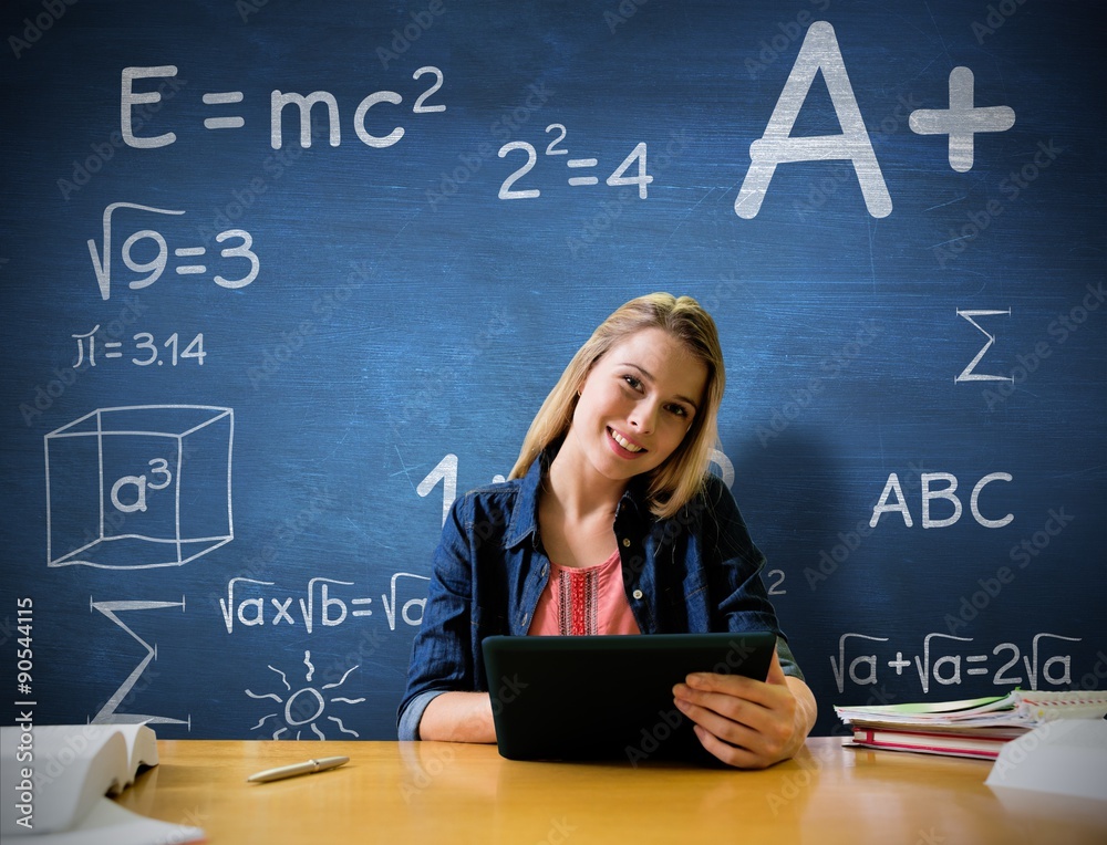 Composite image of student studying in the library with tablet