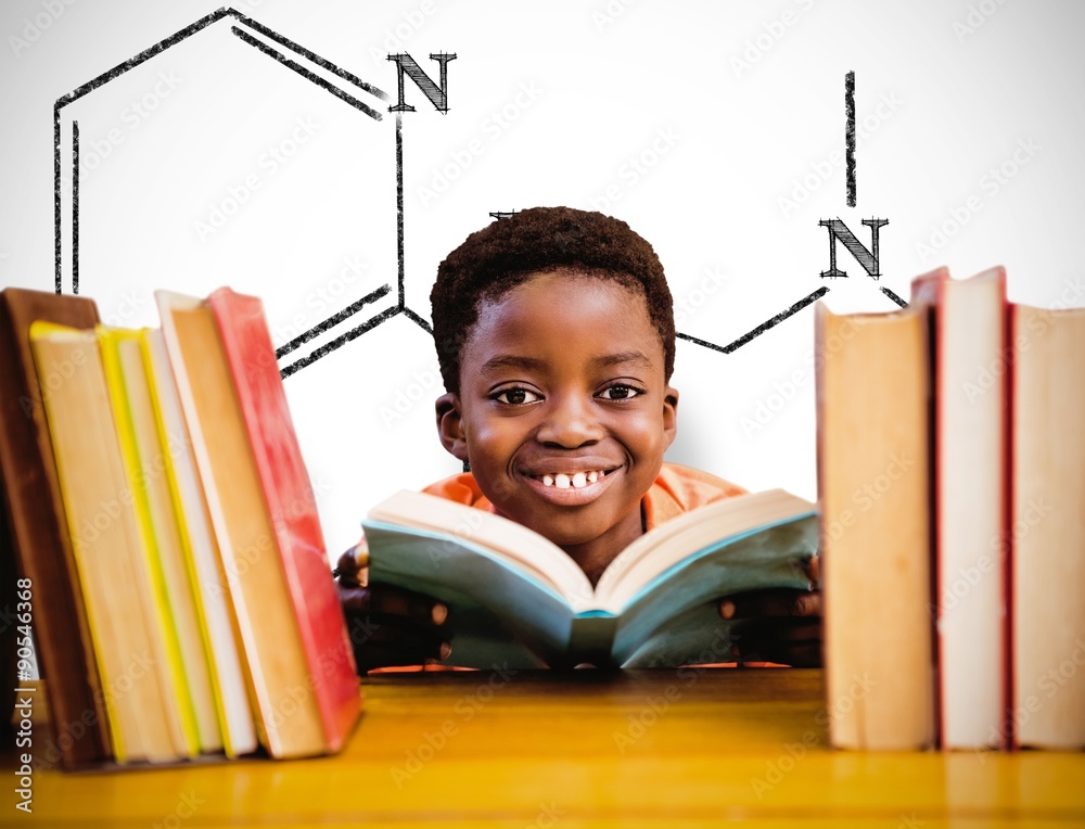 Composite image of cute boy reading book in library