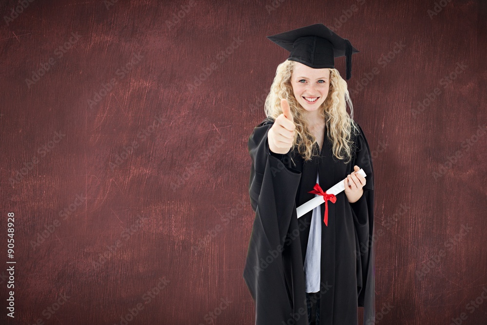 Teenage girl celebrating graduation with thumbs up