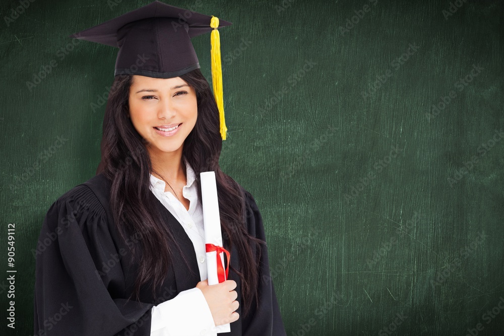 Woman standing to the side slightly with her degree