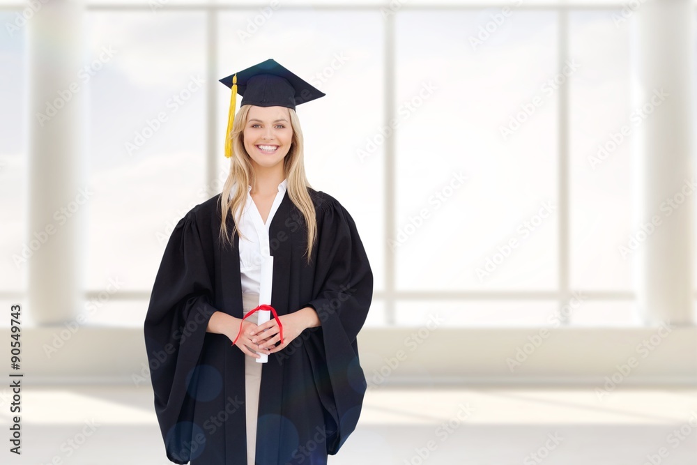 Composite image of smiling blonde student in graduate robe