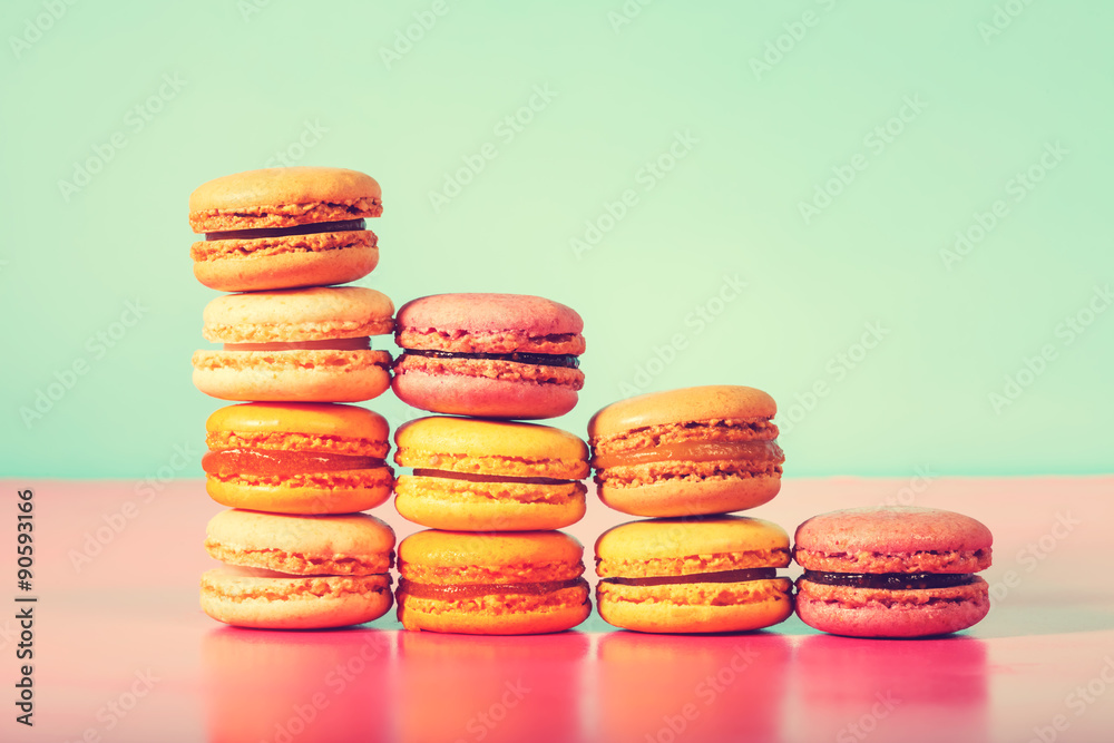 Colorful macarons on a bright pastel background