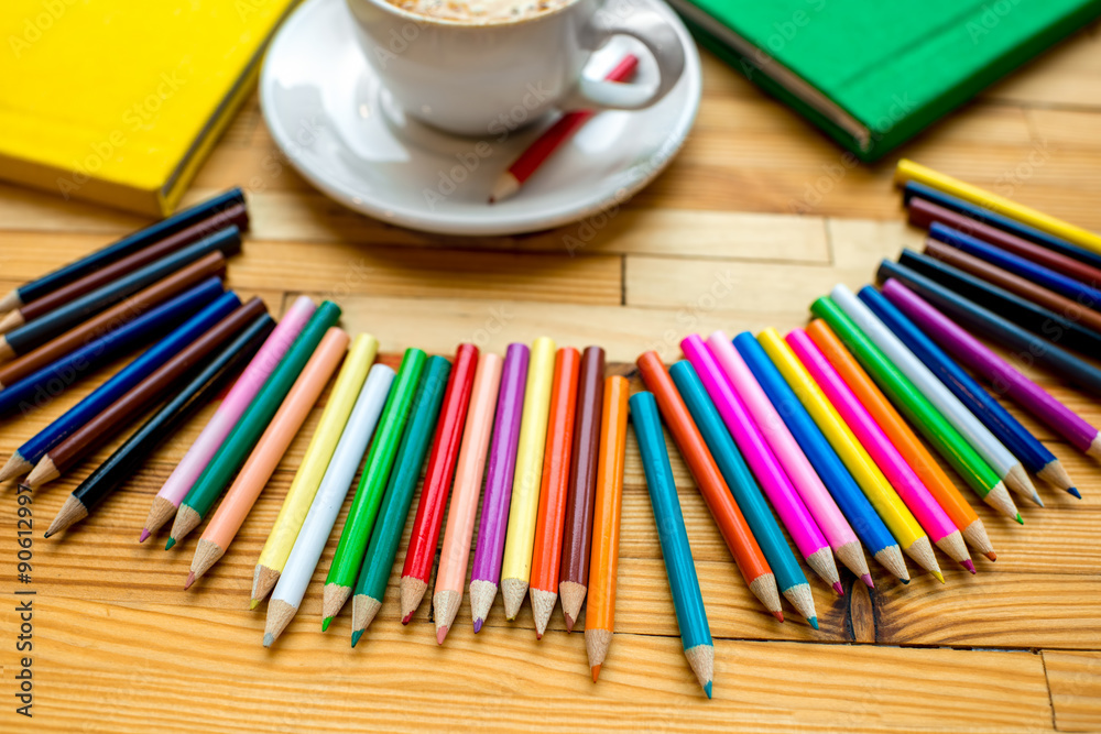 Colorful pencils with books and coffee