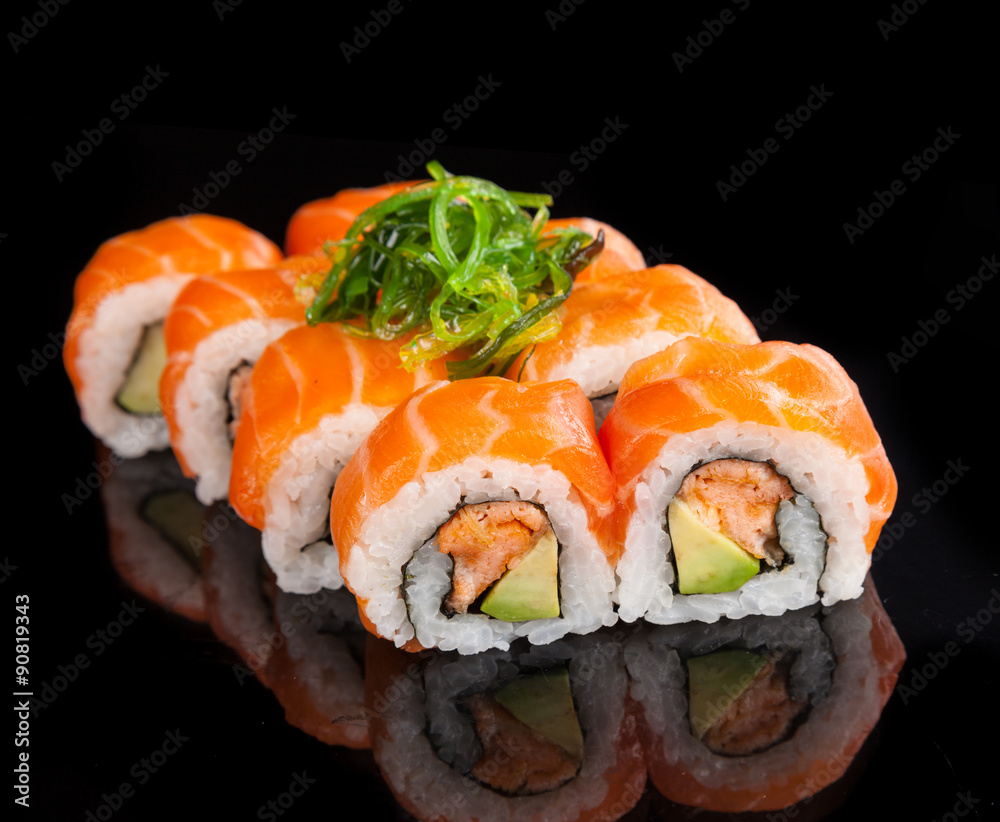 Maki sushi served on black background