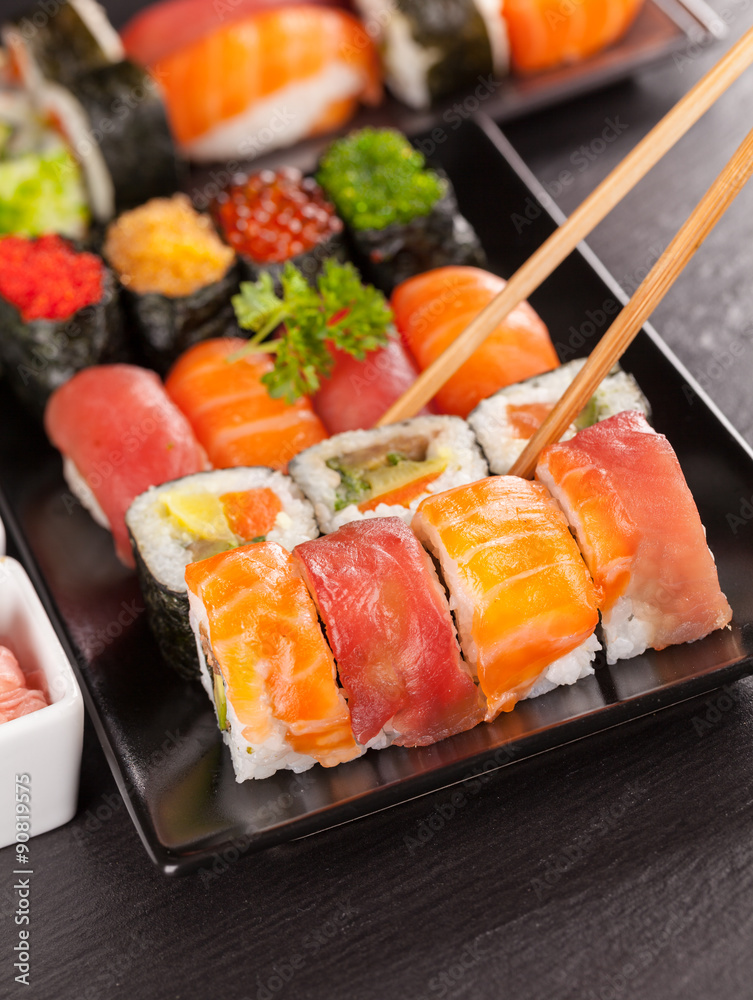 sushi pieces with chopsticks