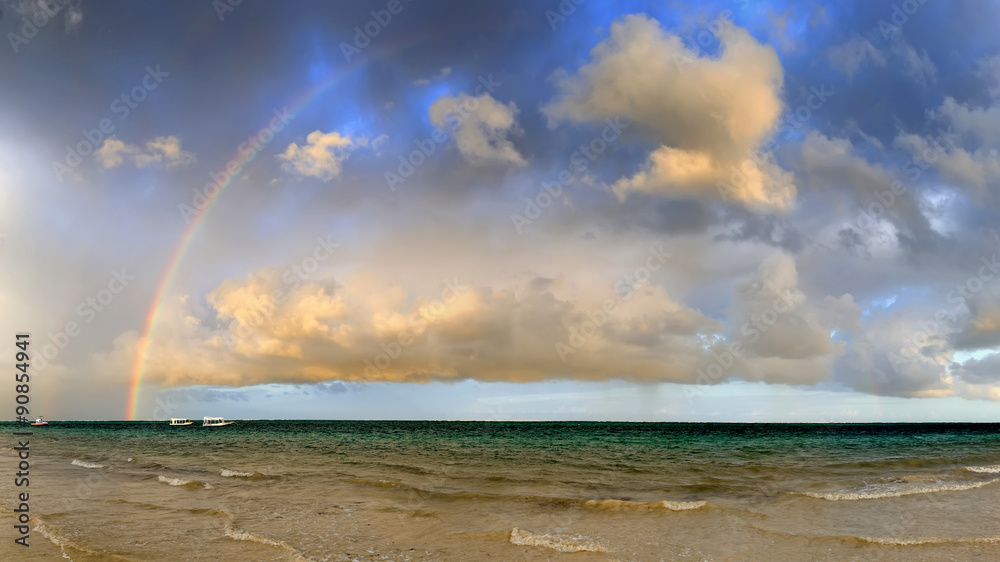 Boat and rainbow in ocean