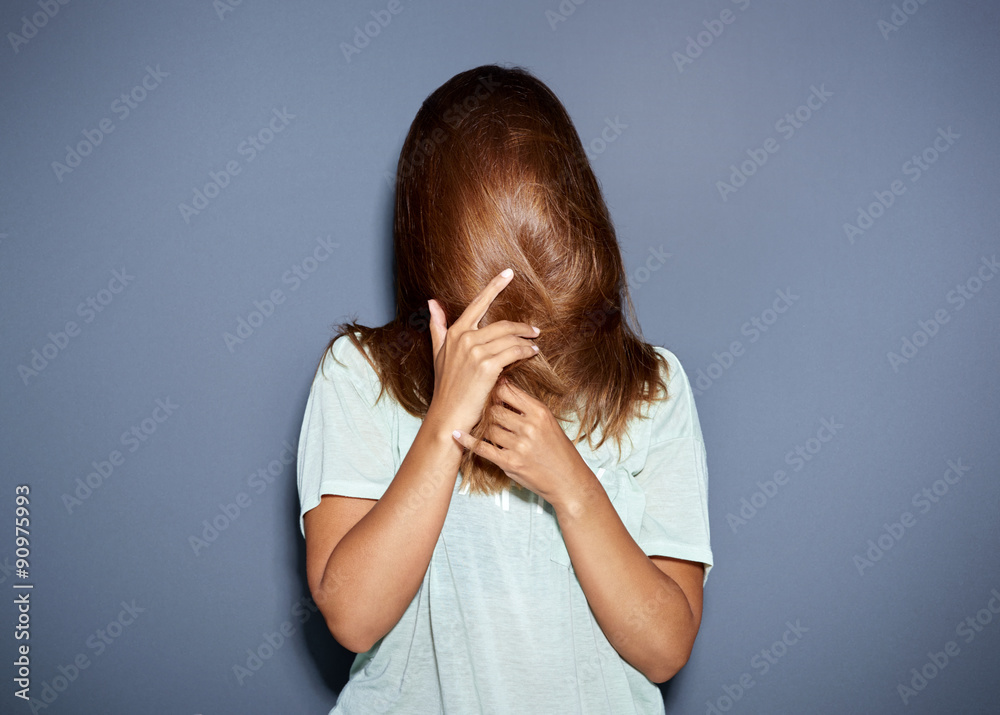 Fun portrait of a woman hiding behind her hair