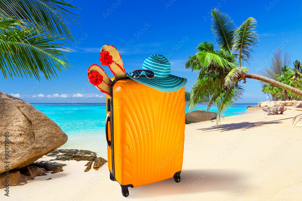 Summer holidays with baggages on the tropical beach