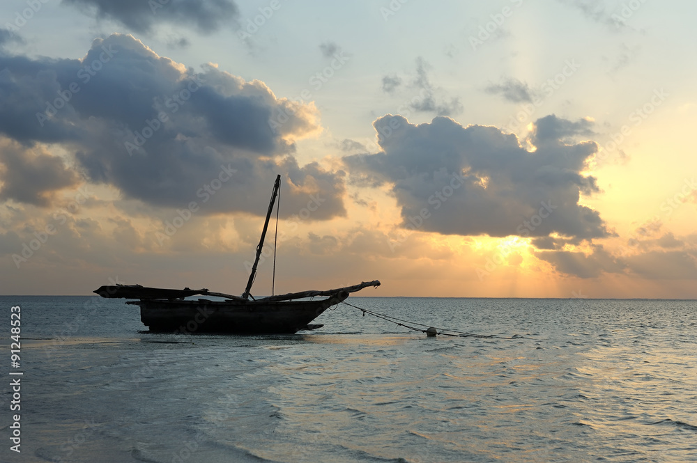 Sunset and old wooden fishing boat