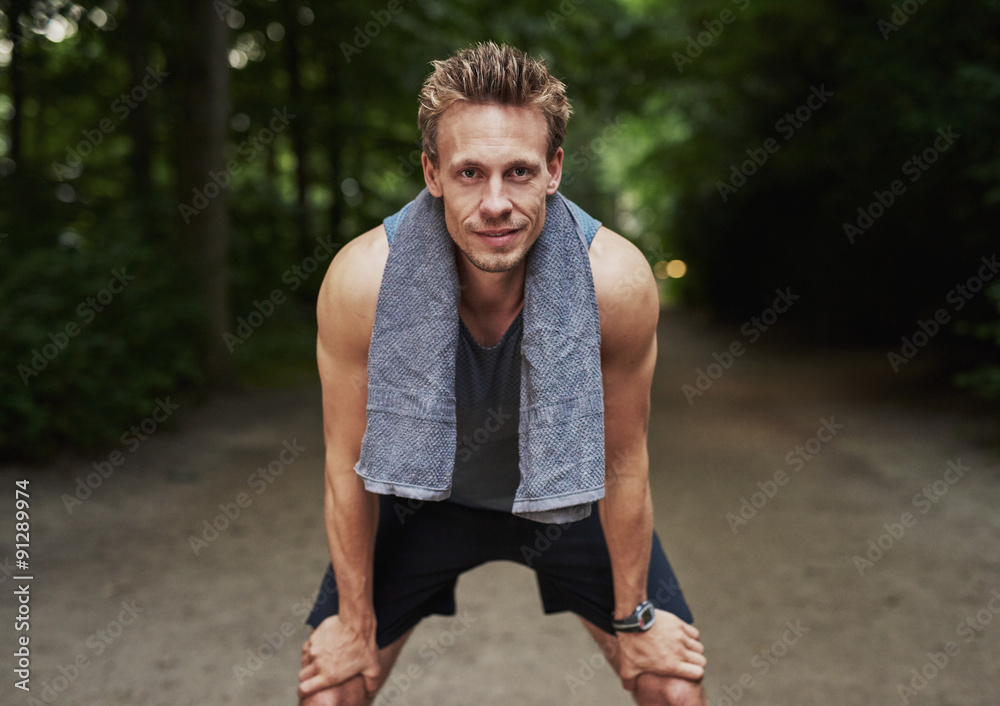 Man with Towel on his Neck Resting After Exercise