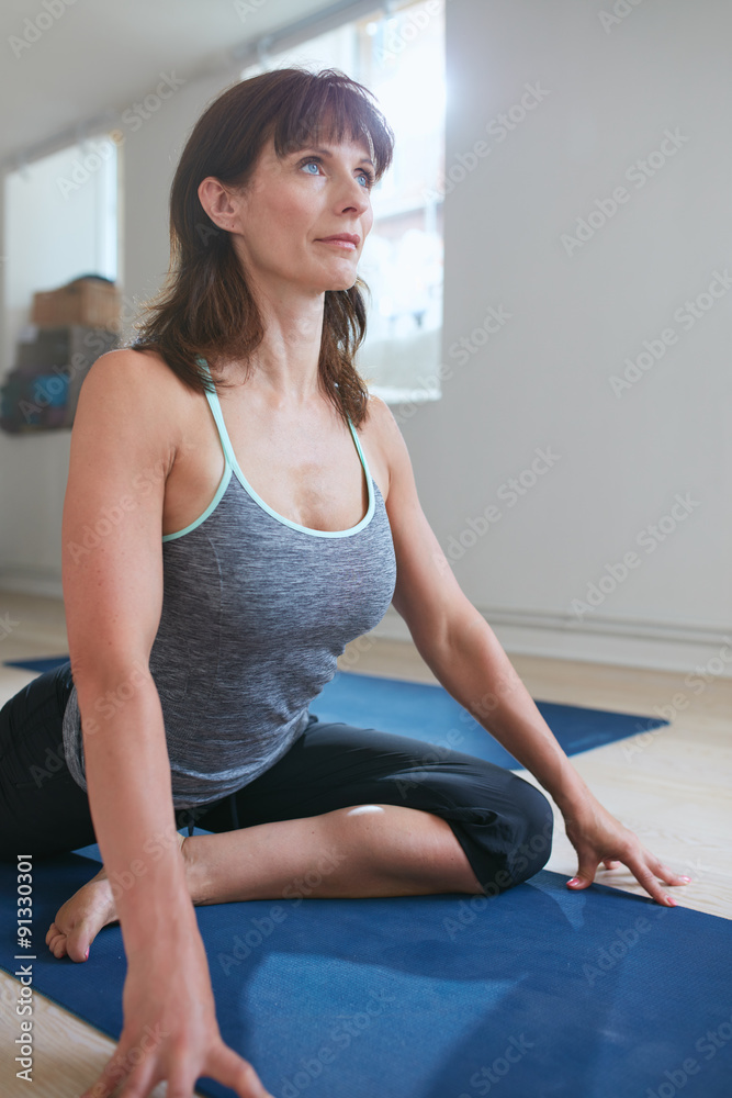 Fit woman doing yoga at gym