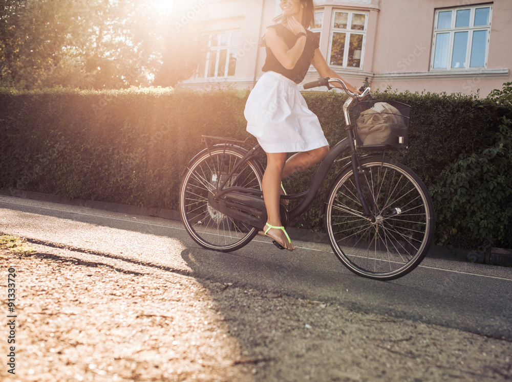 Woman riding bicycle along the street