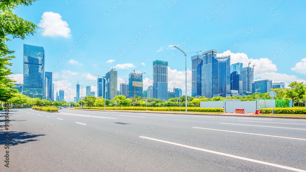 asphalt road and skyscrapers of modern city