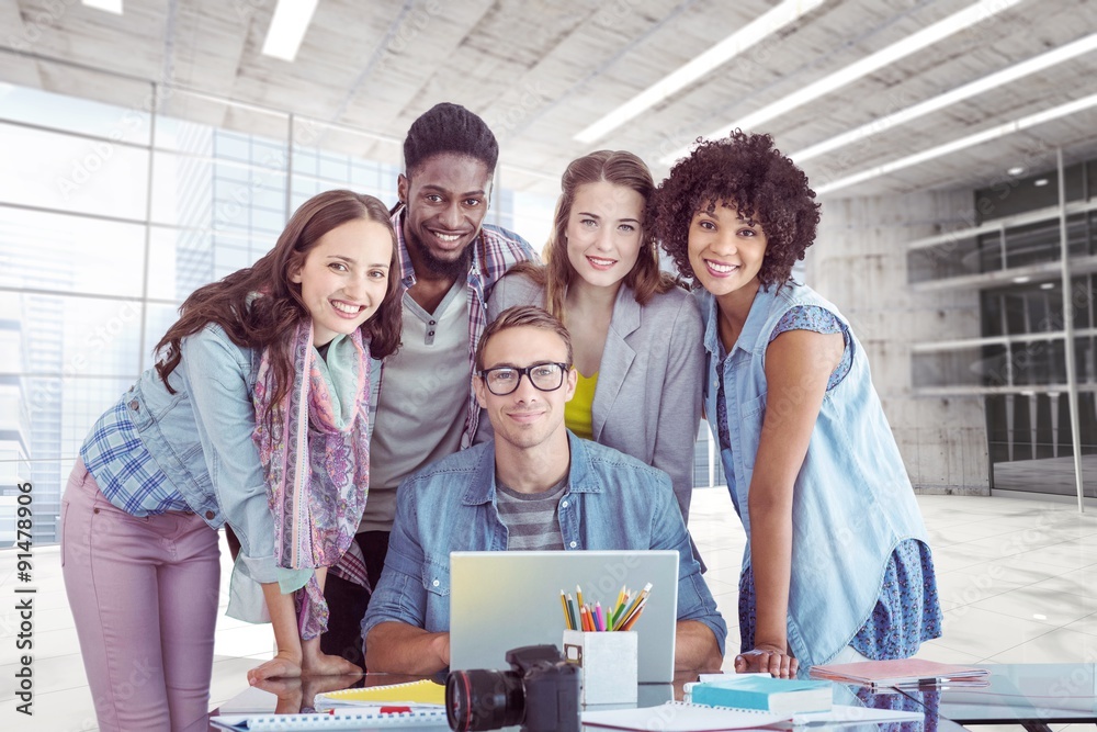 Composite image of fashion students working as a team 