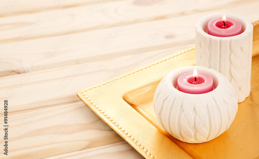 lovely lit candle on light wooden table