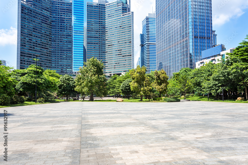 modern square and skyscrapers under blue sky