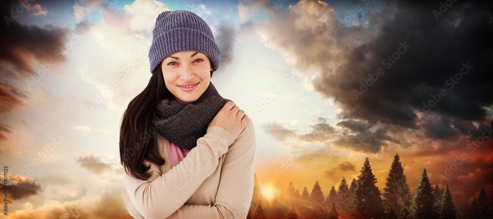 Composite image of attractive brunette looking at camera