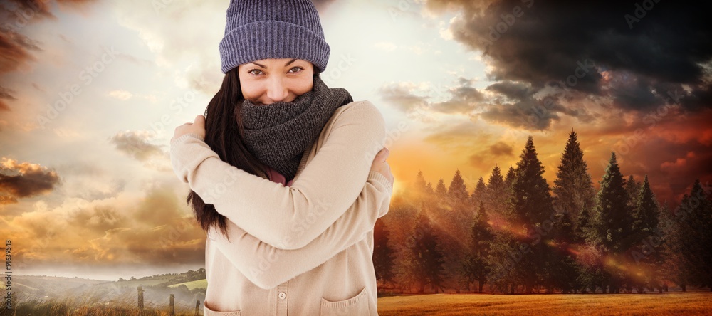 Composite image of attractive brunette looking at camera