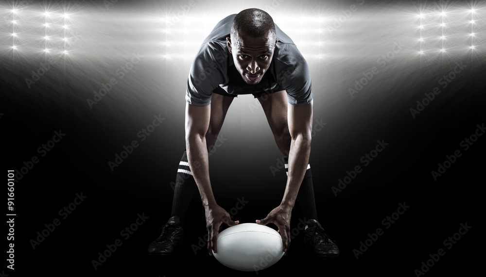 Composite image of portrait of sportsman holding ball 