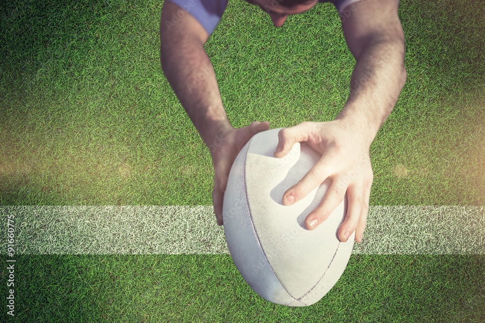 Composite image of rugby player ready to tackle the opponent