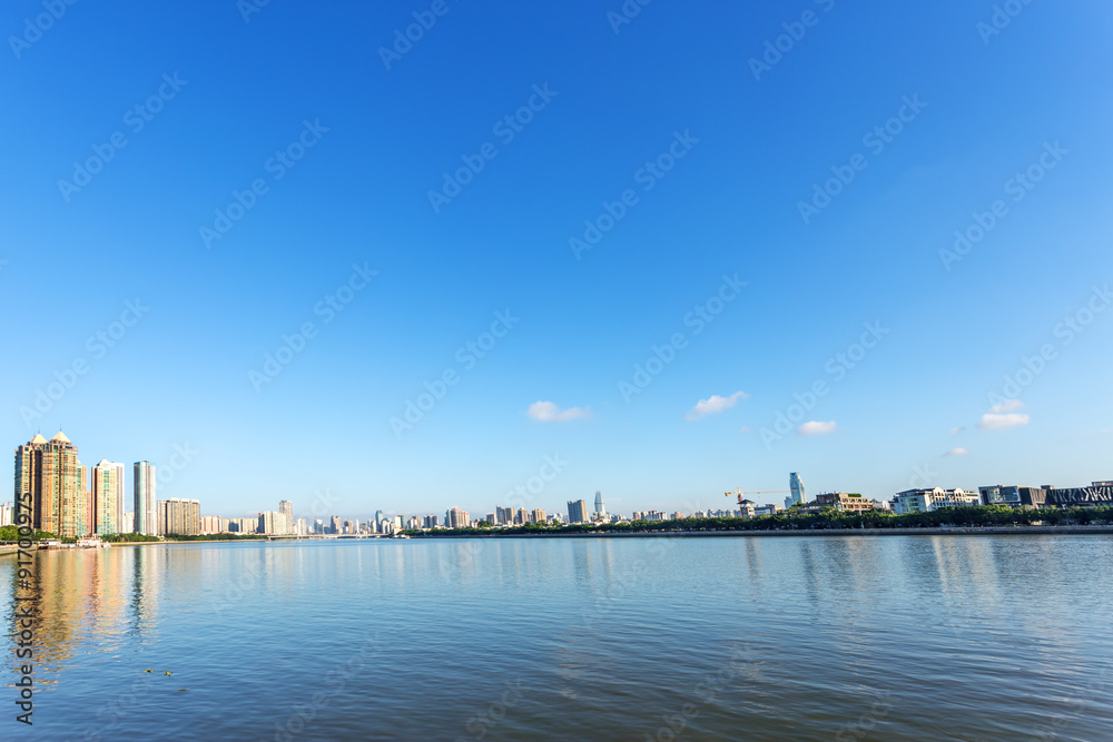 skyscrapers by the river bank