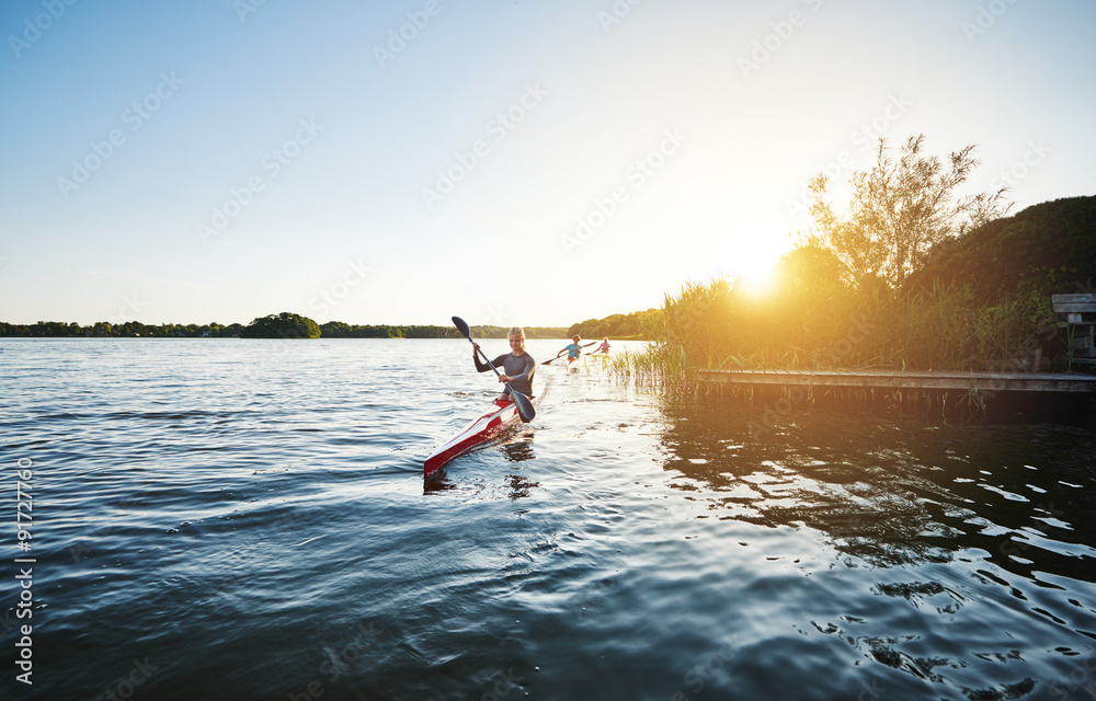 Woman kayaking in the sunset