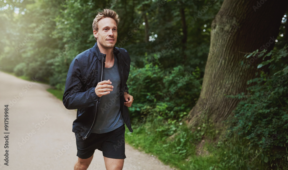 Healthy Man in Jacket Jogging at the Park