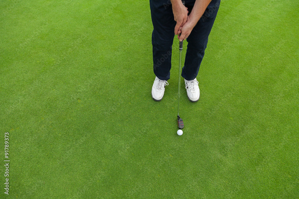 Golf player at the putting green