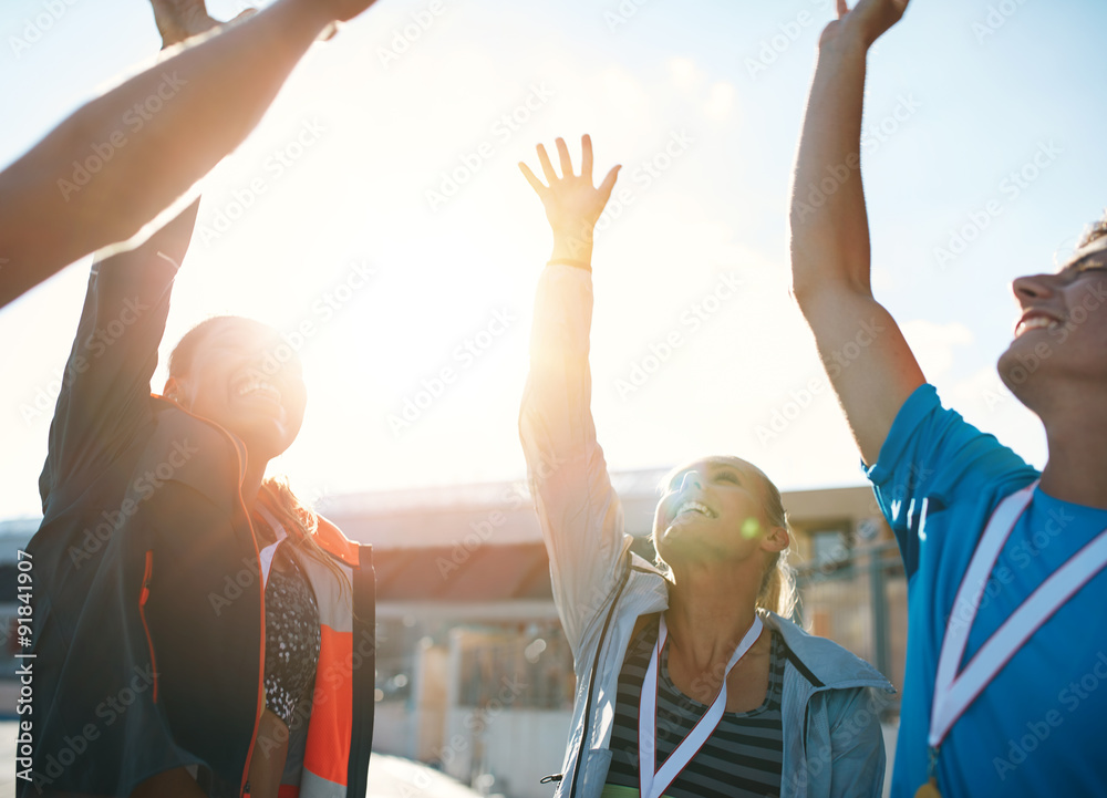 Successful team of athletes cheering victory