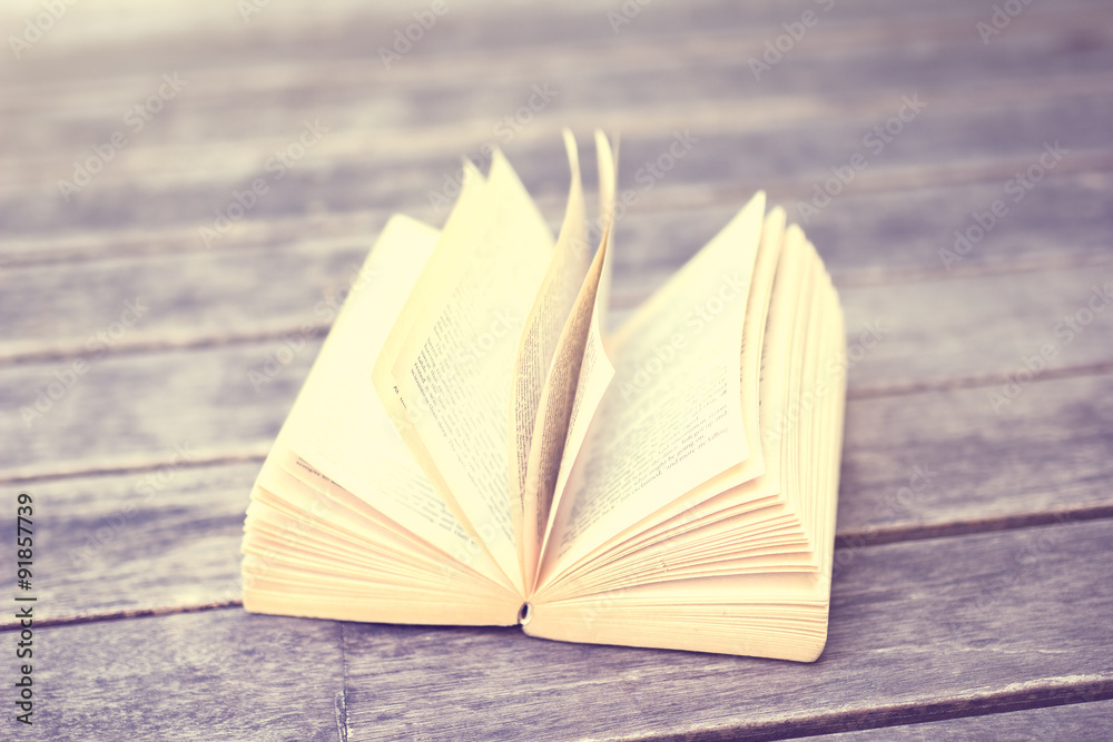 open book on a wooden table