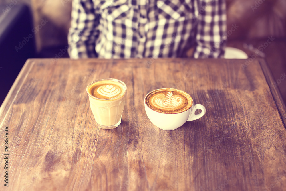 wooden table with two cups of coffee