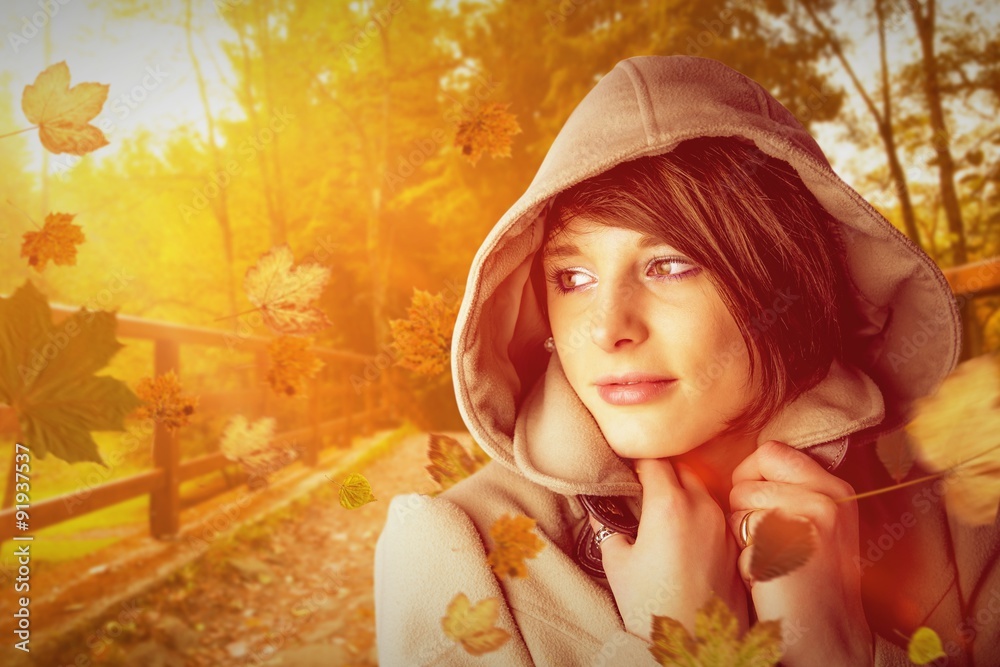 Composite image of beautiful woman wearing winter coat