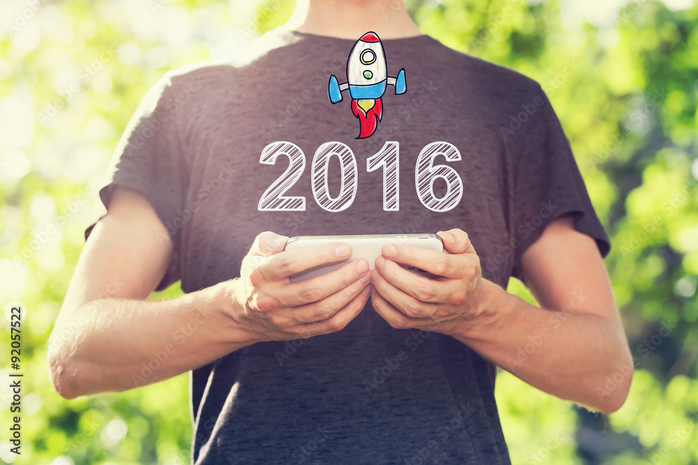 2016 concept with young man holding his smartphone