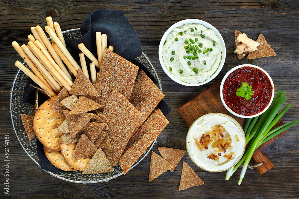 various dip sauces and bowl of bread cookies