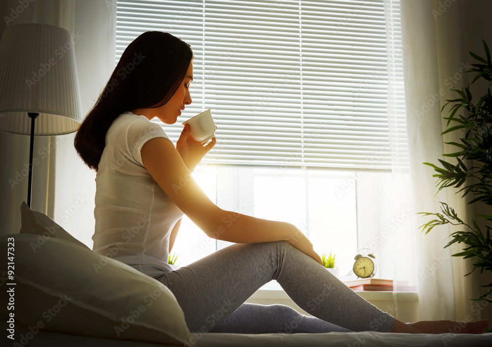 woman sitting on bed