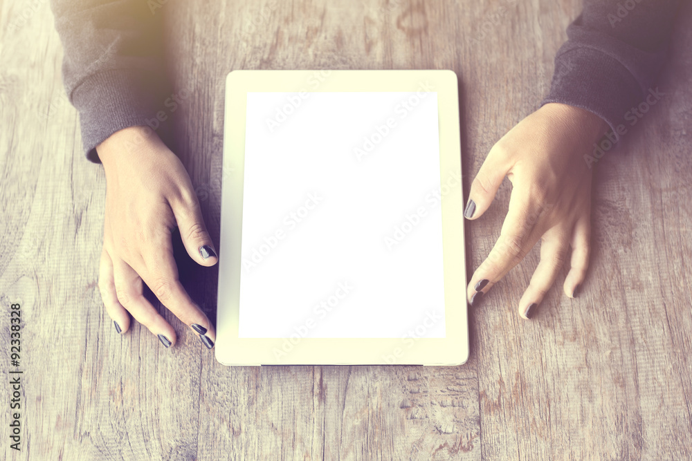 Girl with blank tablet on a wooden table, mock up