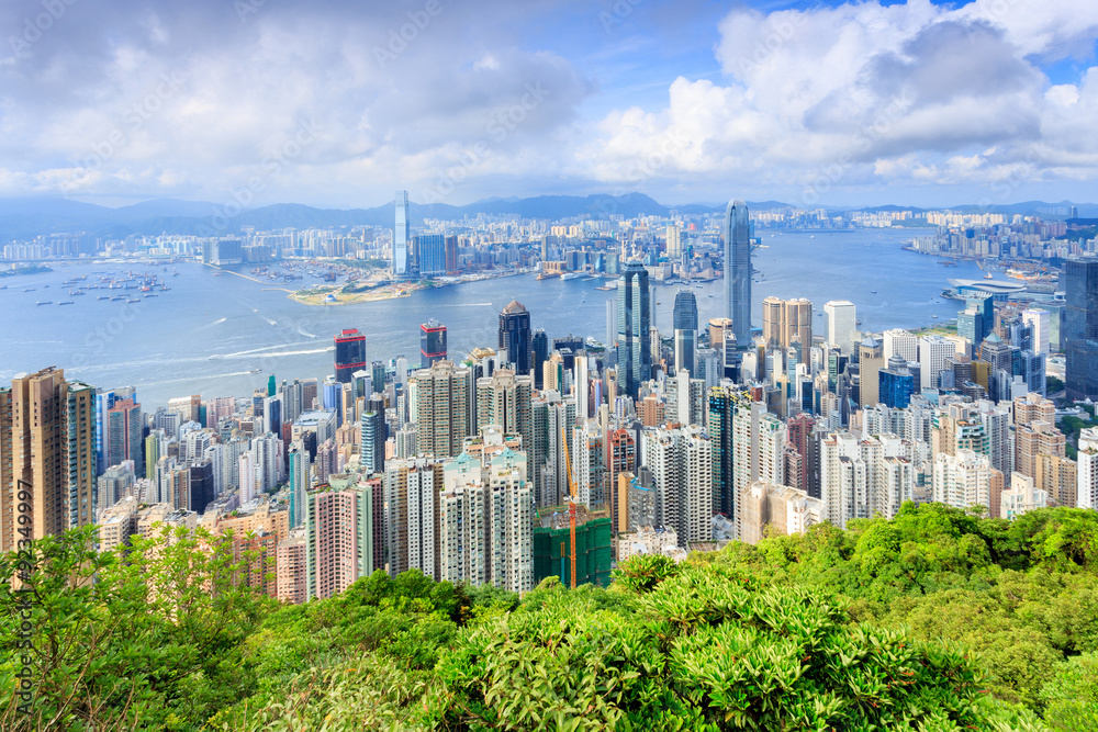 city skyscrapers besides a mountain and a river