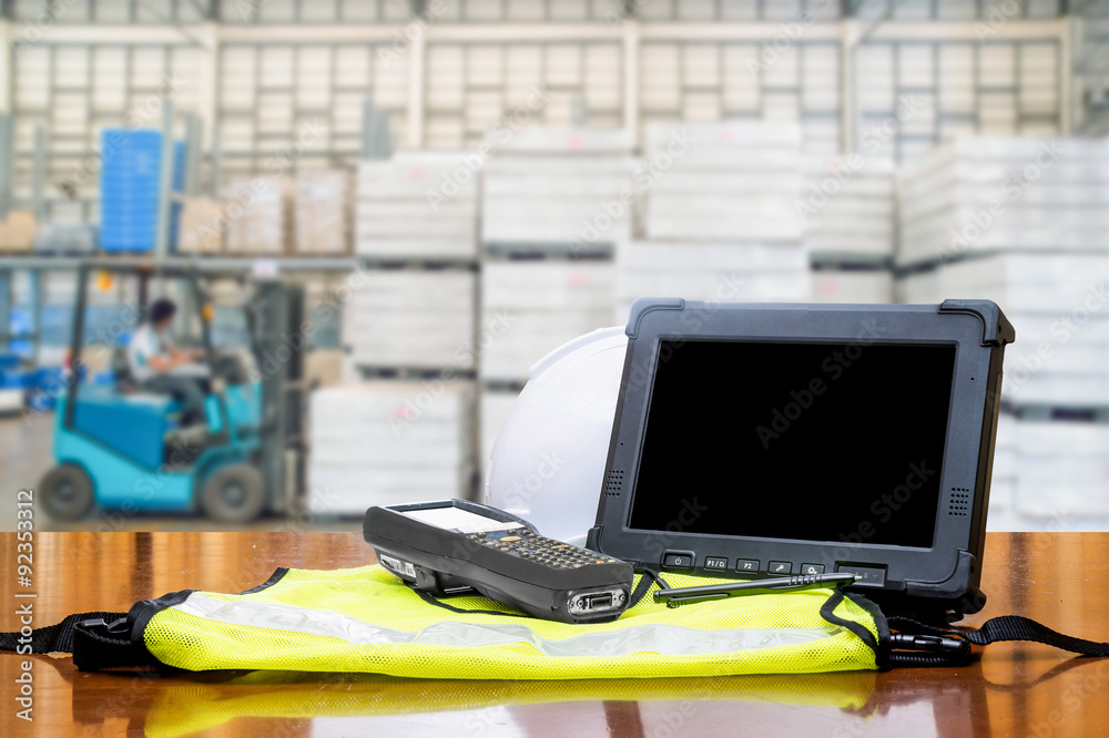 Rugged computers tablet and Bluetooth barcode scanner in front o