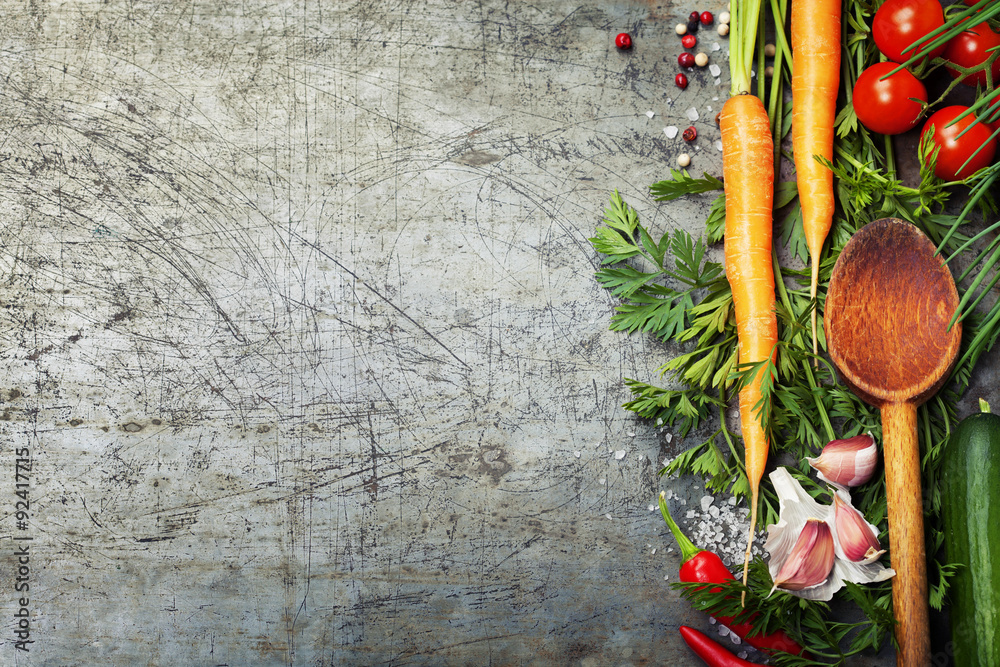 Wooden spoon and ingredients on old background