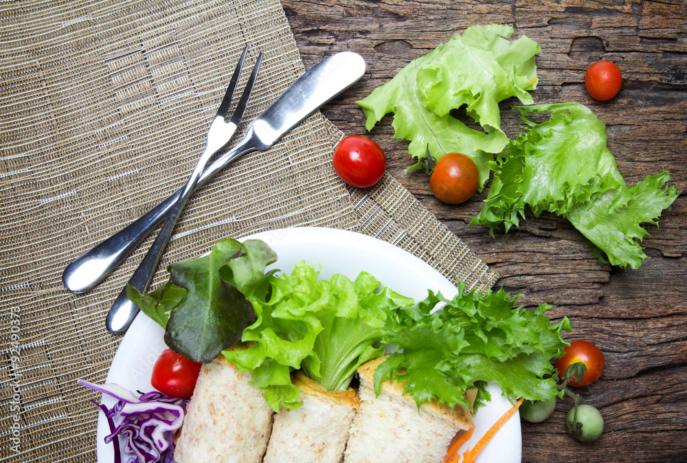 fresh whole wheat bread wraps with vegetables and fruit on the p